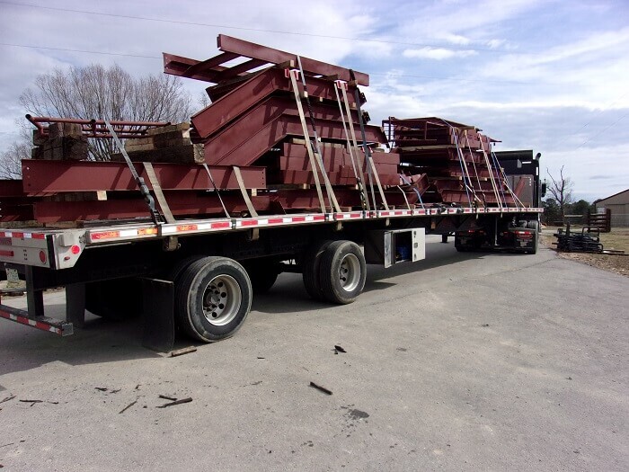 three stacks of metal on a trailer